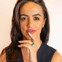 Model wears set of enamel coloured rings in teal, green and blue