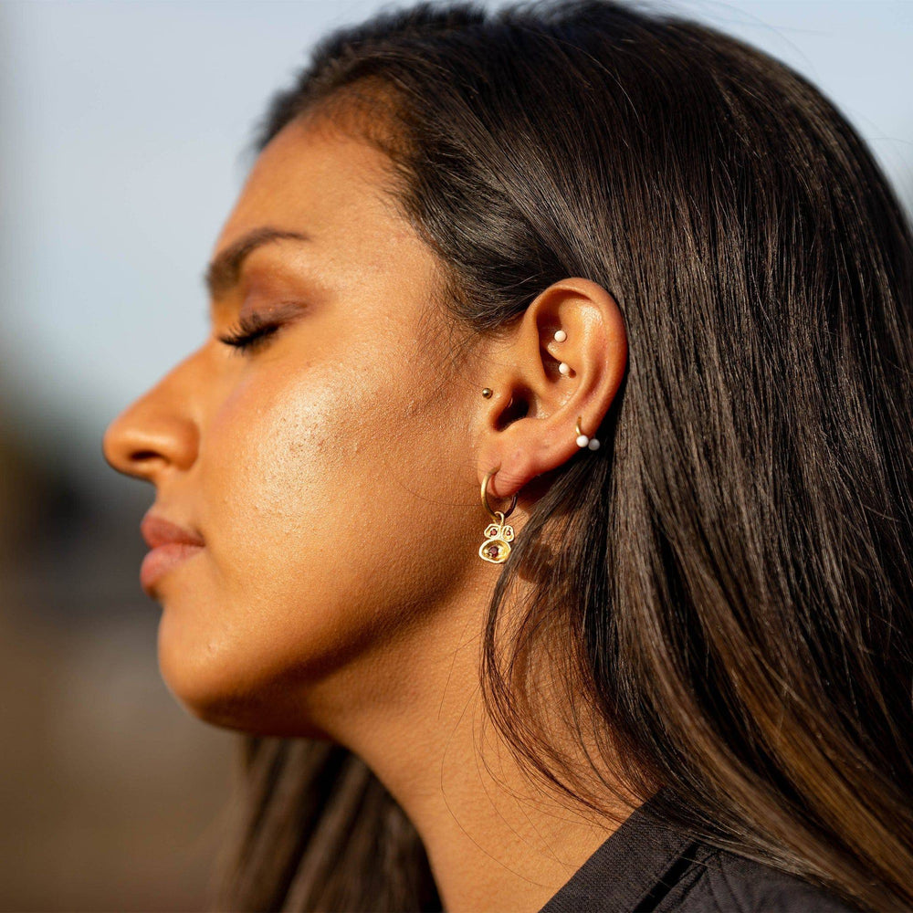 model wears Garnet and Gold Lichen Hoop Earrings