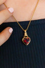 model wears garnet hand in heart gold charm necklace