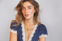 model wears garnet hand in heart gold charm necklace on heart connector