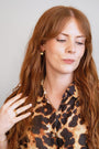 model wears Ginkgo Leaf Gold Earrings and ginkgo gold leaf necklace