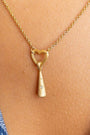 model wears Sparkly Comet Gold Charm Necklace on heart connector chain