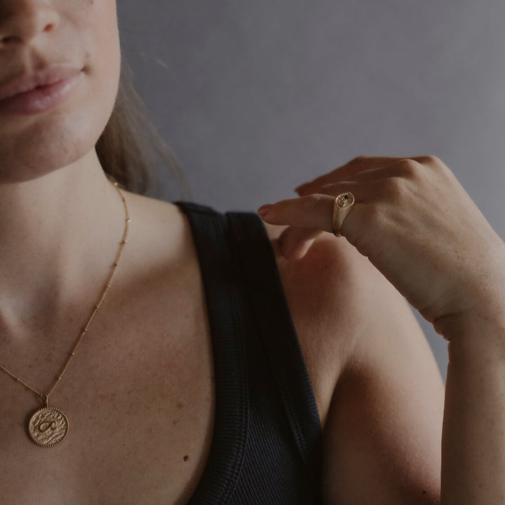 model wears “Fuck” Gold Shorthand Coin Necklace