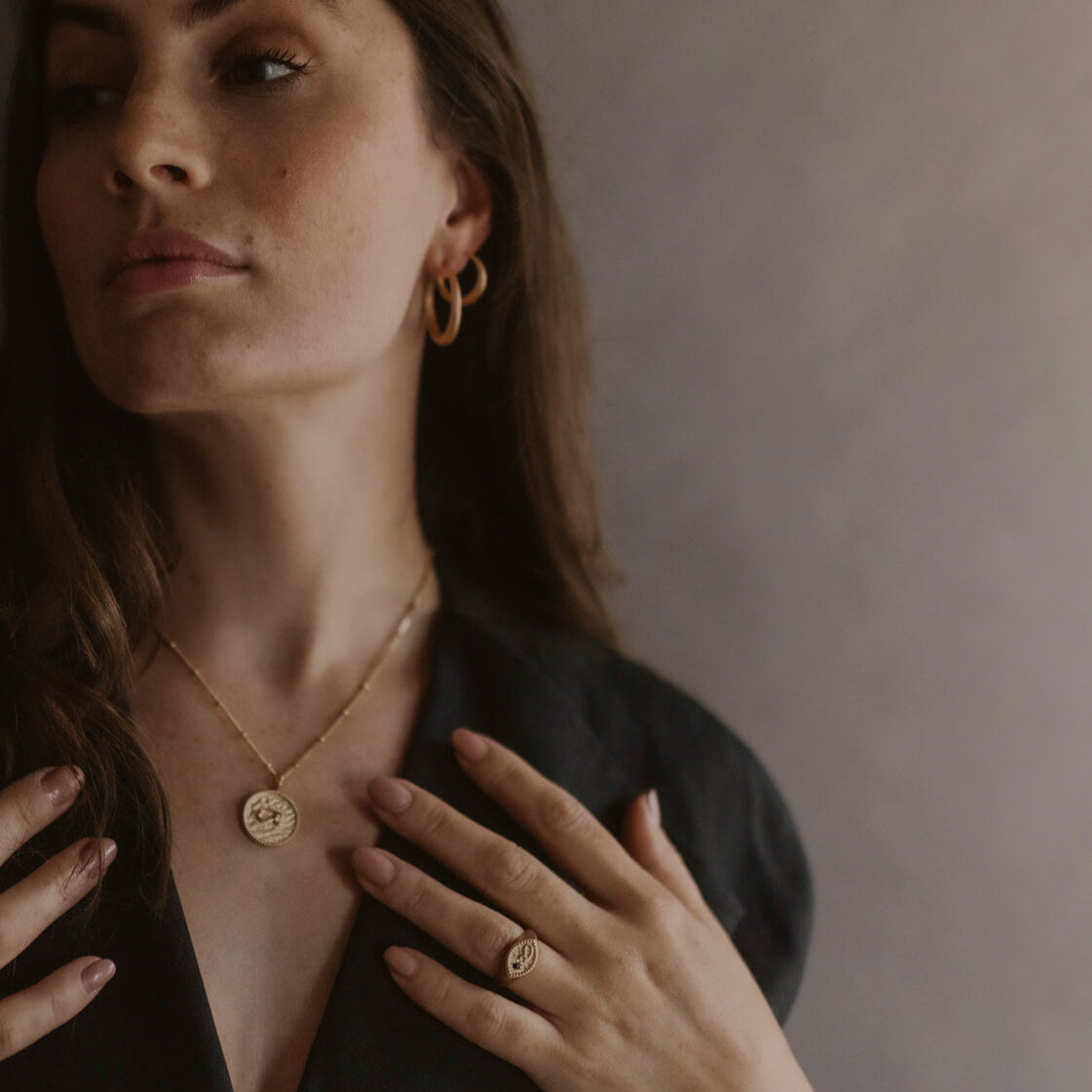 model wears “Fuck” Gold Shorthand Coin Necklace and Fuck gold signet ring