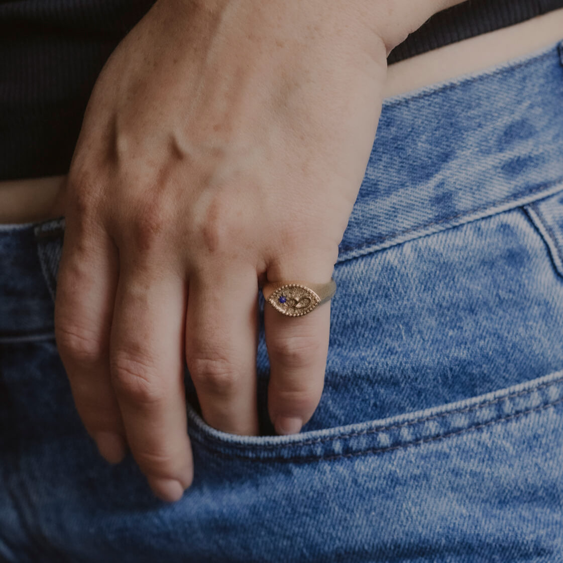 model wears Fuck Gold Shorthand Signet Ring