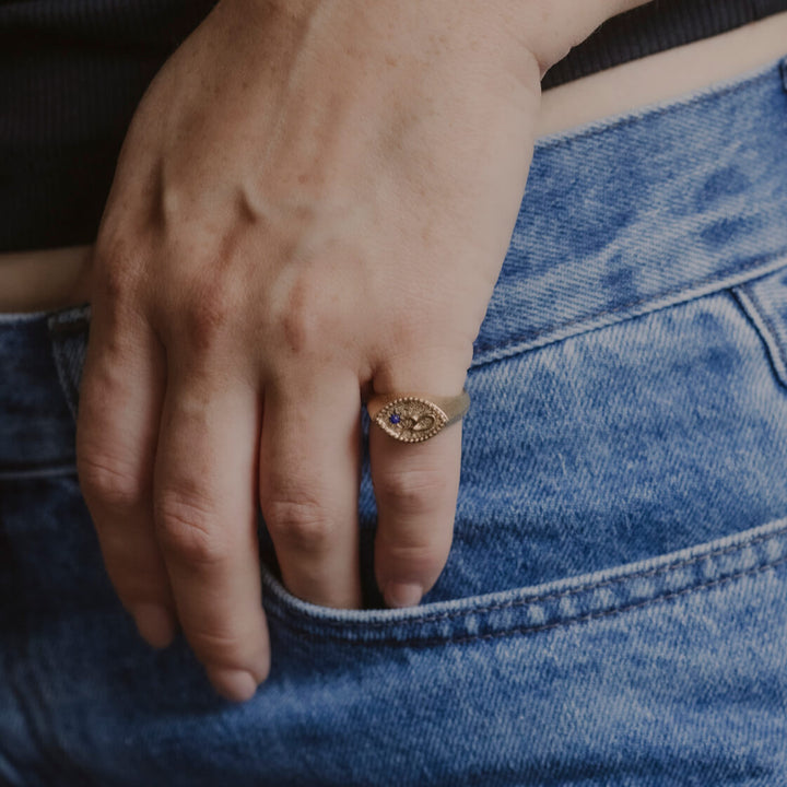 model wears Fuck Gold Shorthand Signet Ring