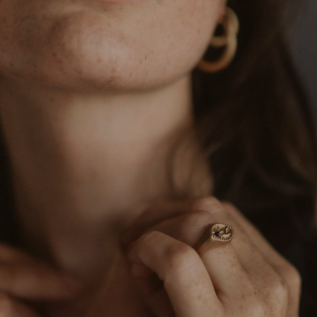 model wears Fuck Gold Shorthand Signet Ring