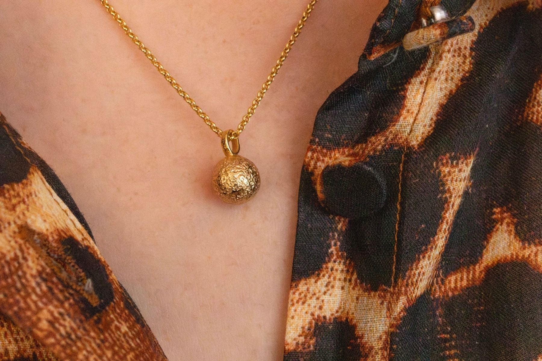 model wears gold moon charm necklace