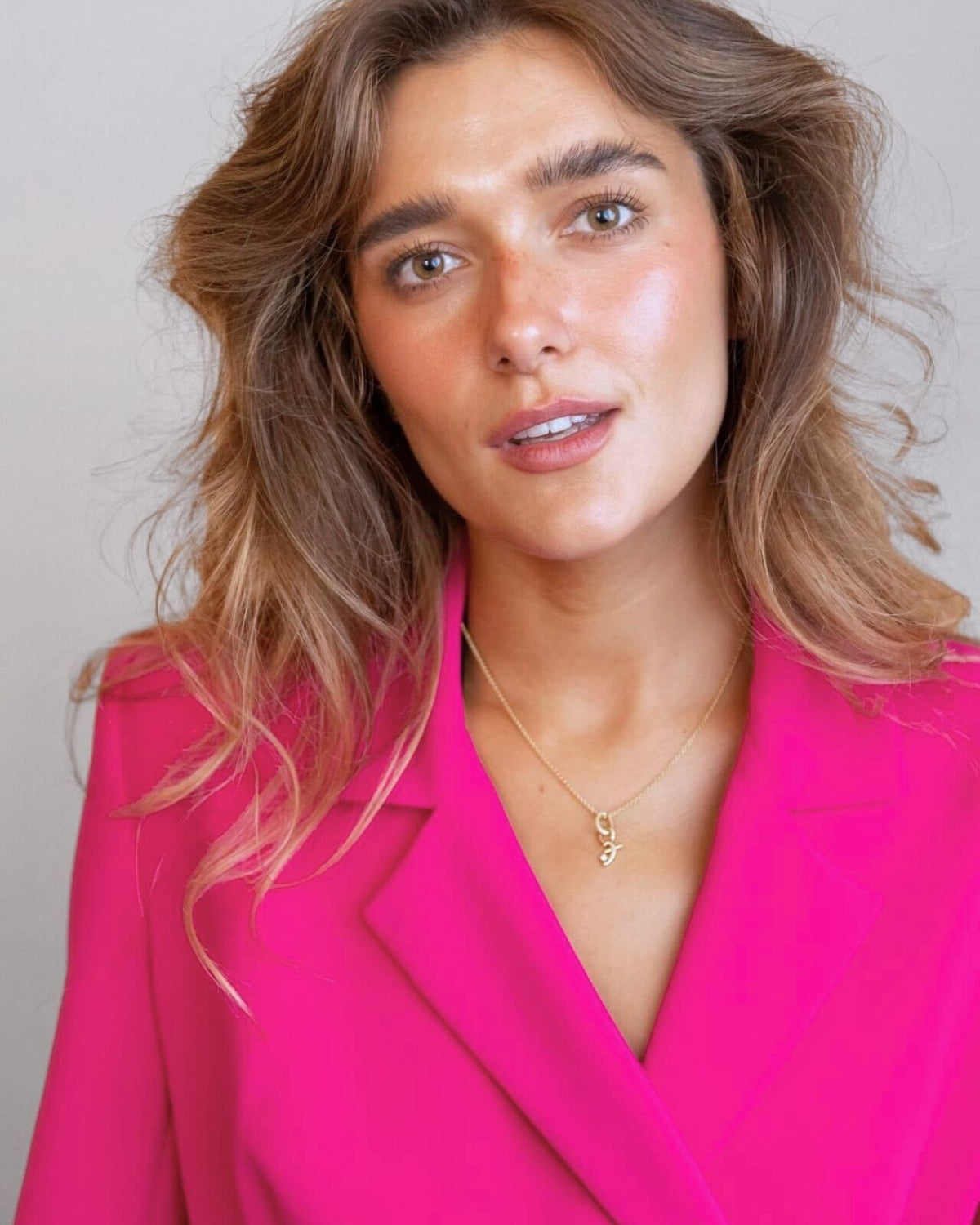 model wears great gold shorthand pendant on oval connector 
