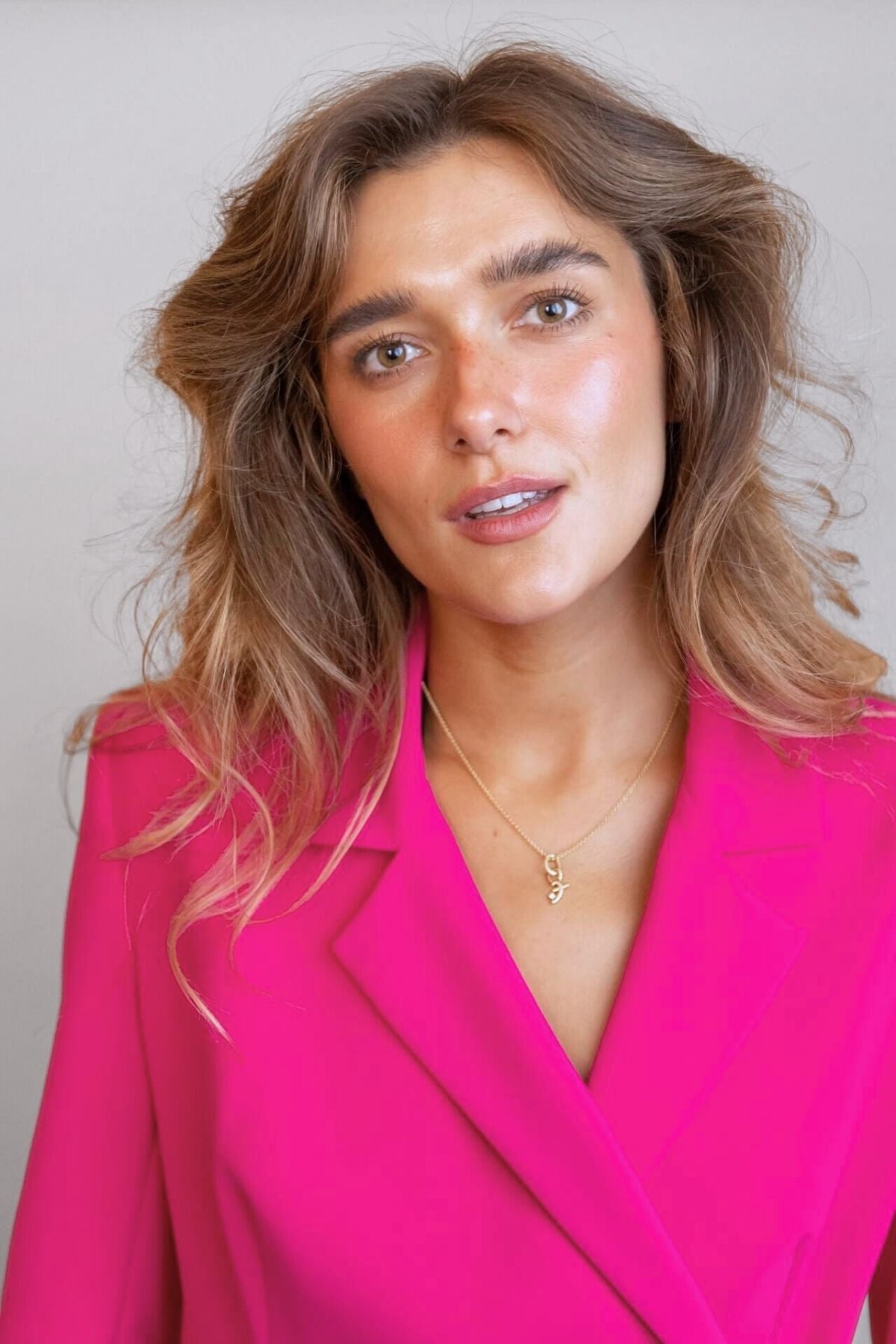 model wears great gold shorthand pendant on oval connector 
