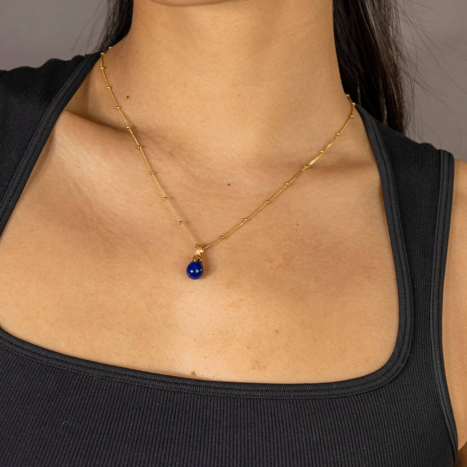 model wears lapis Lazuli Gold Lichen Pendant Necklace on satellite chain  - close up 