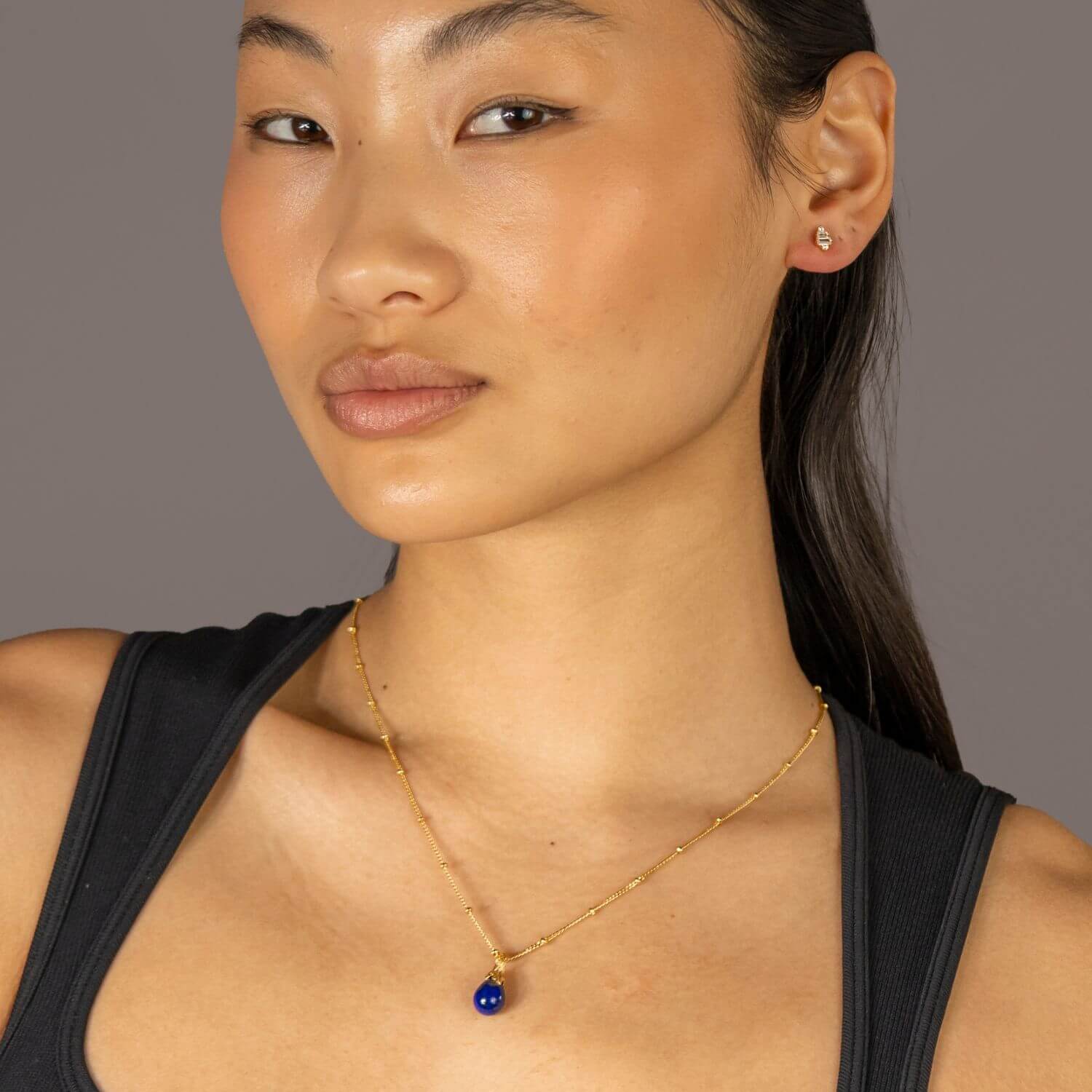 model wears lapis Lazuli Gold Lichen Pendant Necklace on satellite chain - close up
