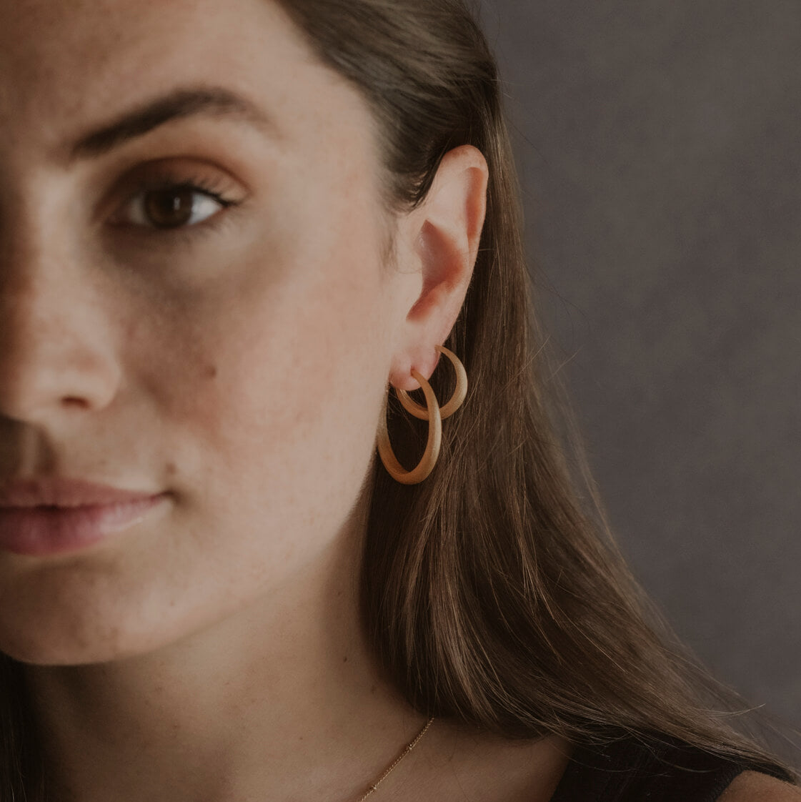 model wears large and medium gold vermeil hoop earrings 