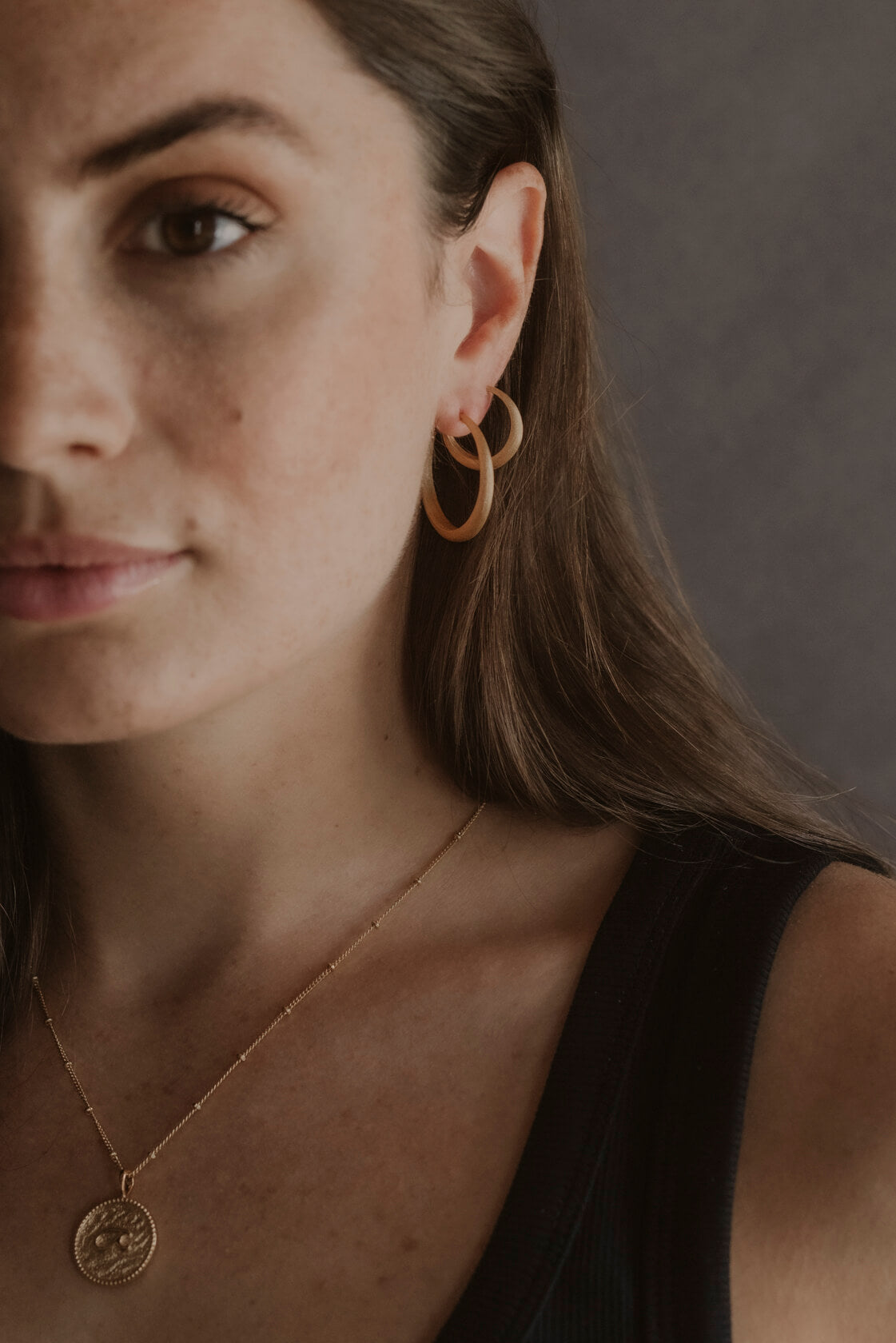 model wears large and medium brushed hoop earrings