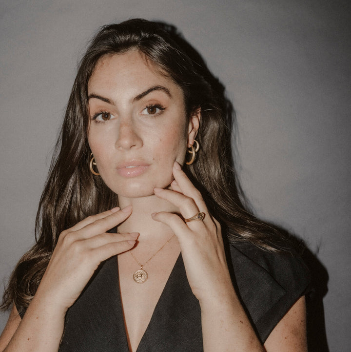 Model wears large 30mm and medium 20mm gold vermeil brushed hoop earrings