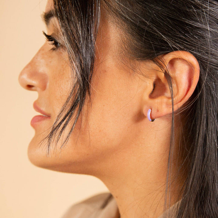 model wears Lavender Enamel Gold Huggie Earrings