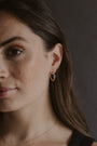 model wears Chalcedony Lichen Branch Gold Medium Hoops