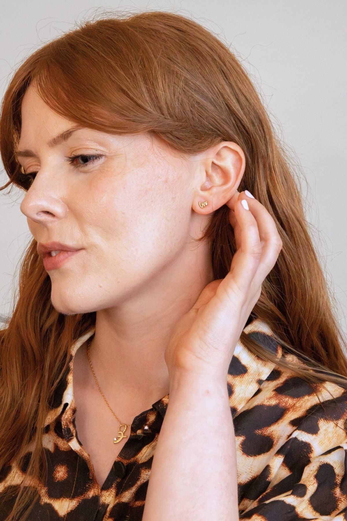 model wears Loved Gold Shorthand Stud Earring