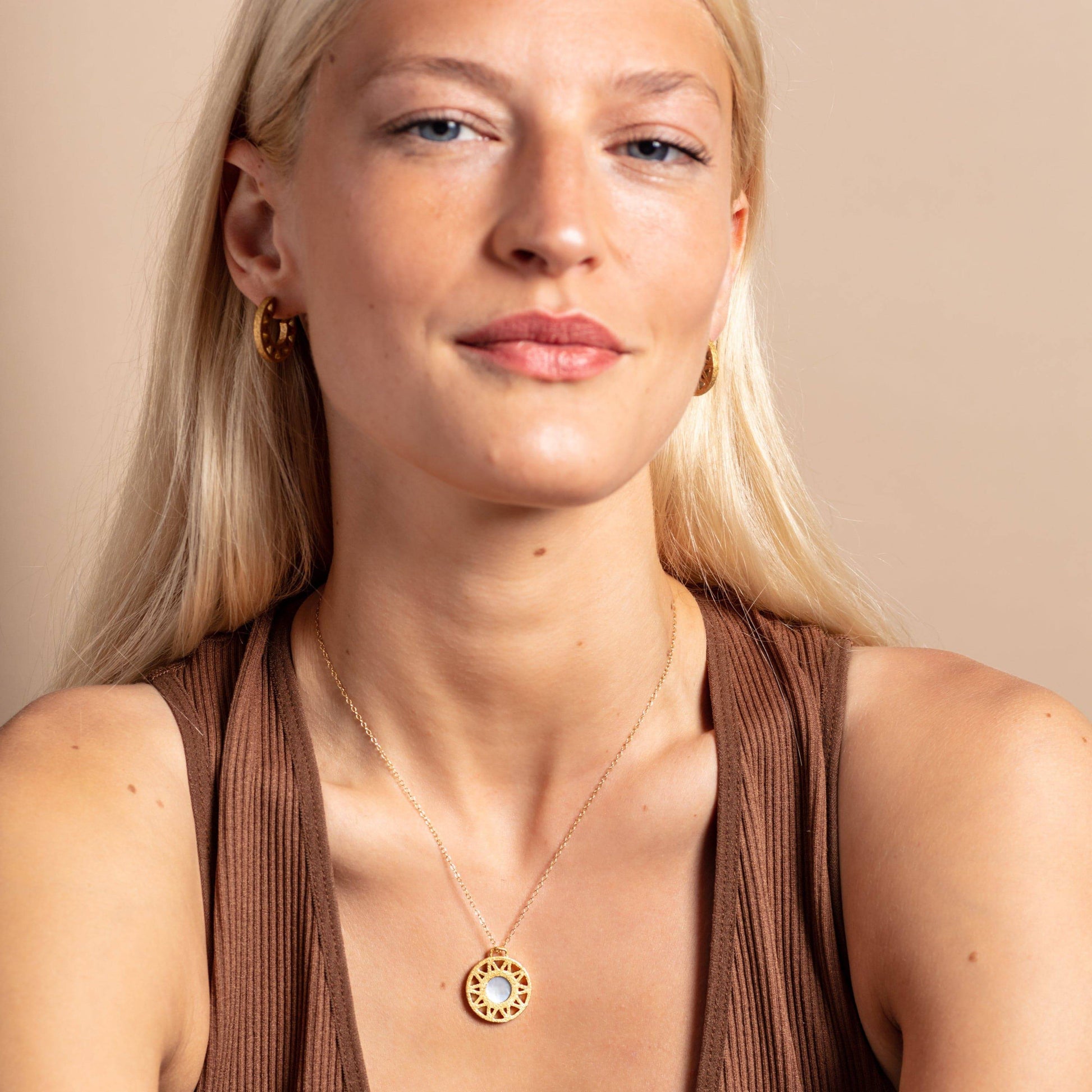 model wears Mother of Pearl and Gold Geometric Disc Necklace