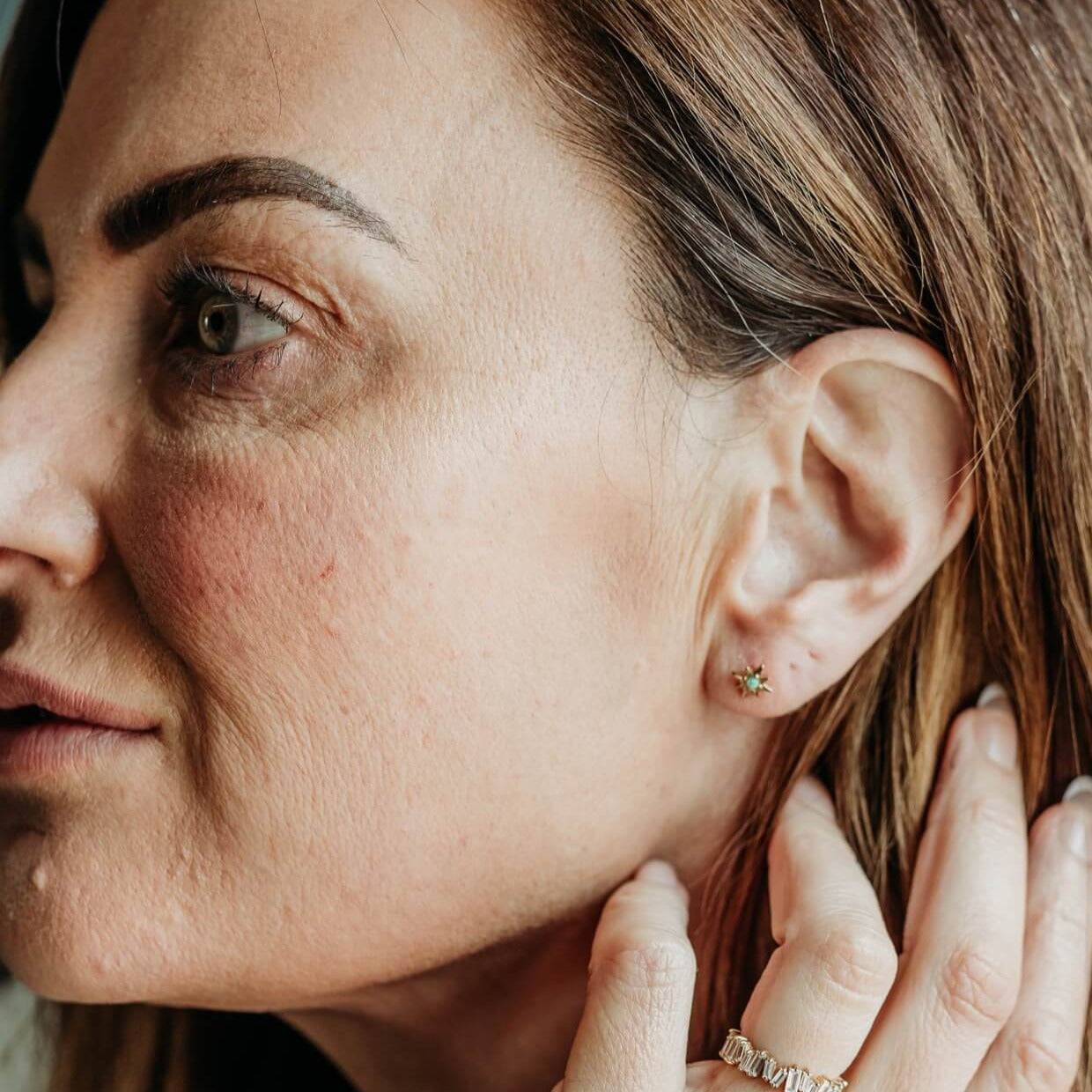 model wears Opal Gold Star Mini Stud Earrings