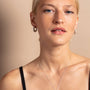 model wears Geometric Silver Hoop Earrings