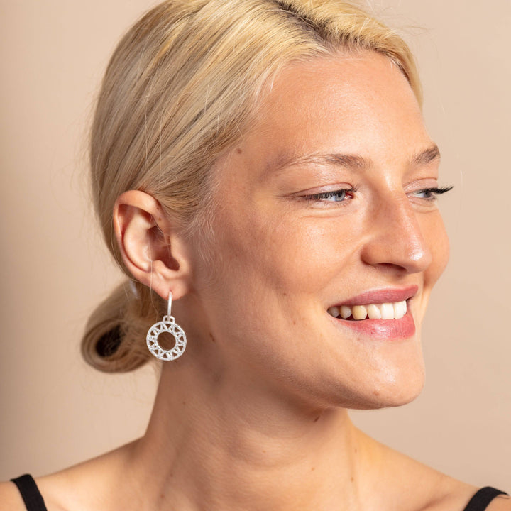 model wears Geometric Statement Silver Hoop Earrings