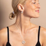 model wears Geometric Silver Disc Pendant Necklace and silver geometric hoop earrings 