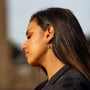 model wears Ruby and Gold Lichen Birthstone Hoop Earrings