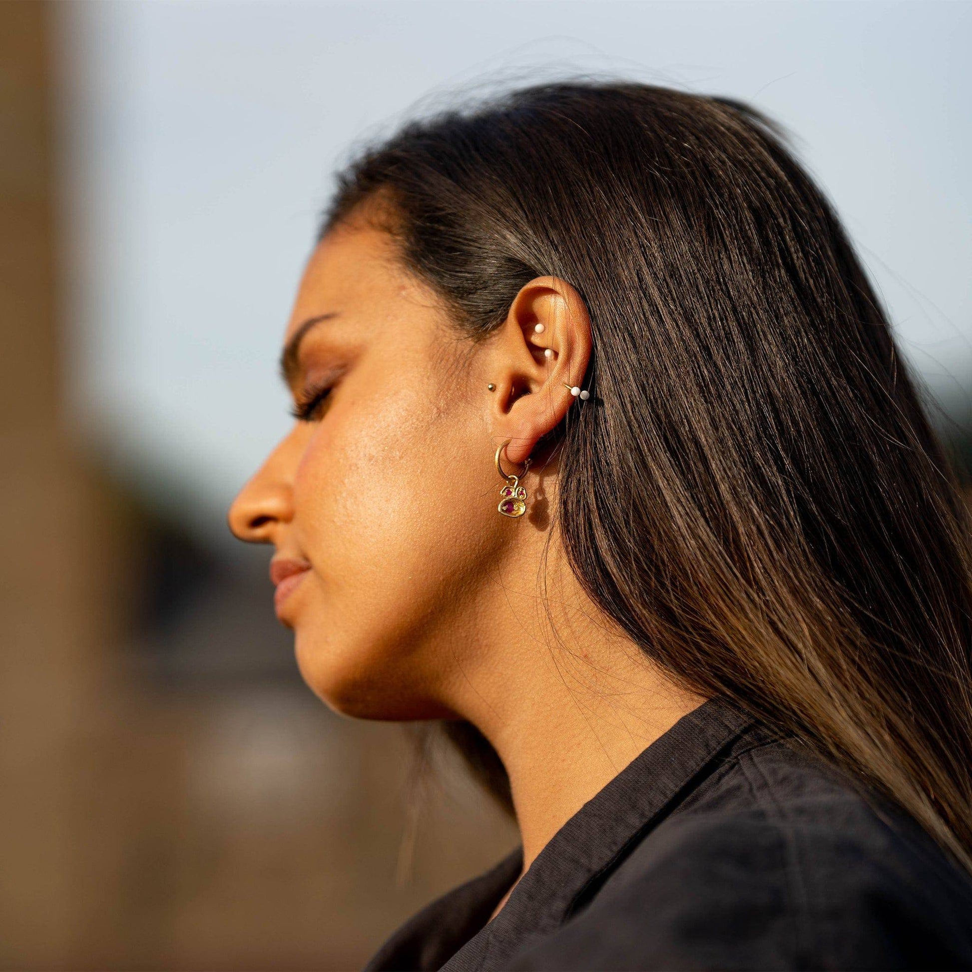 model wears Ruby and Gold Lichen Birthstone Hoop Earrings