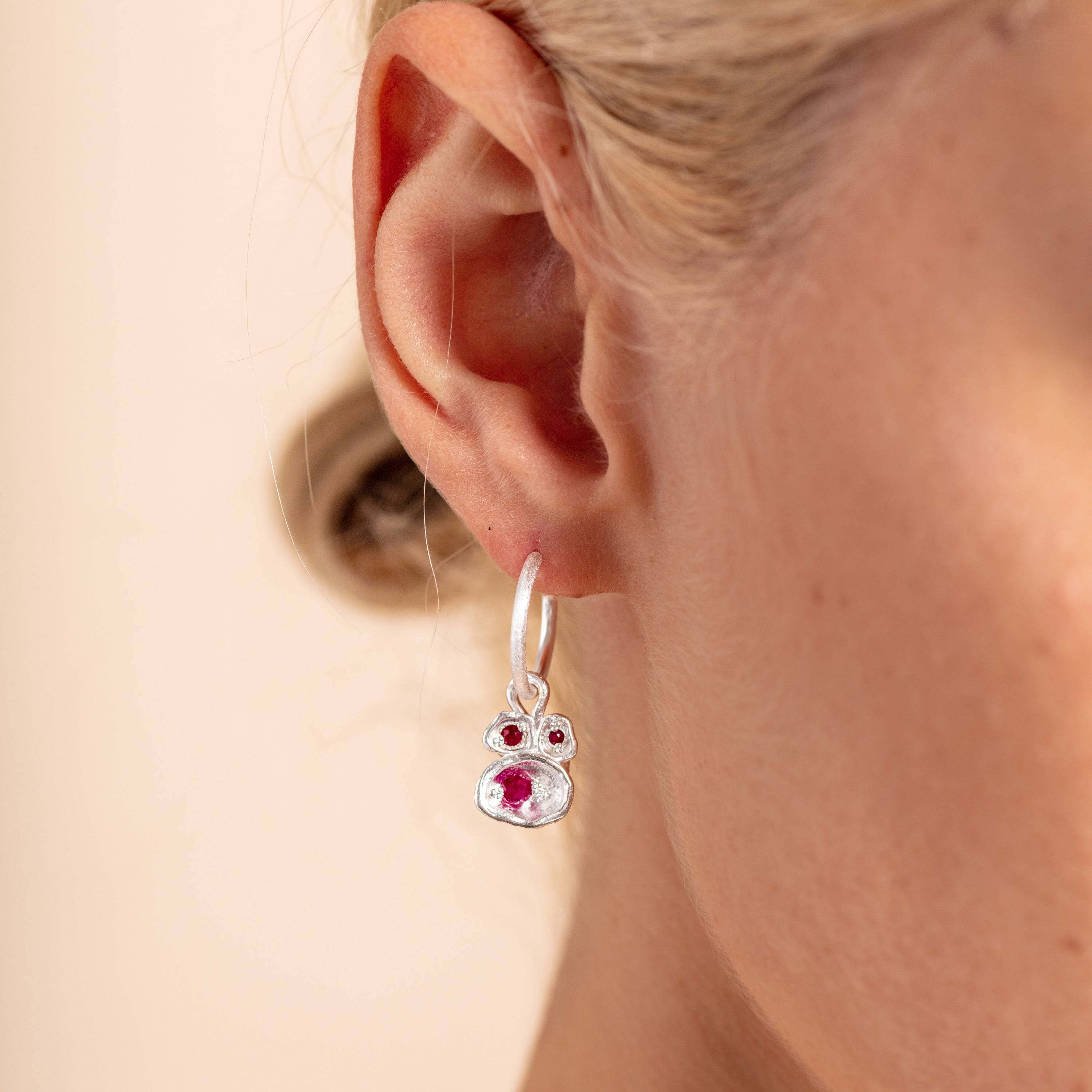 model wears Ruby and Silver Lichen Hoop Birthstone Earrings