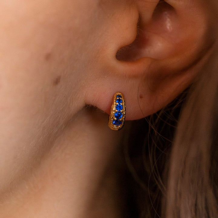 Model wears Sapphire and 18k Gold Vermeil Antique Textured Huggie Hoop Earrings - Claire Hill Designs