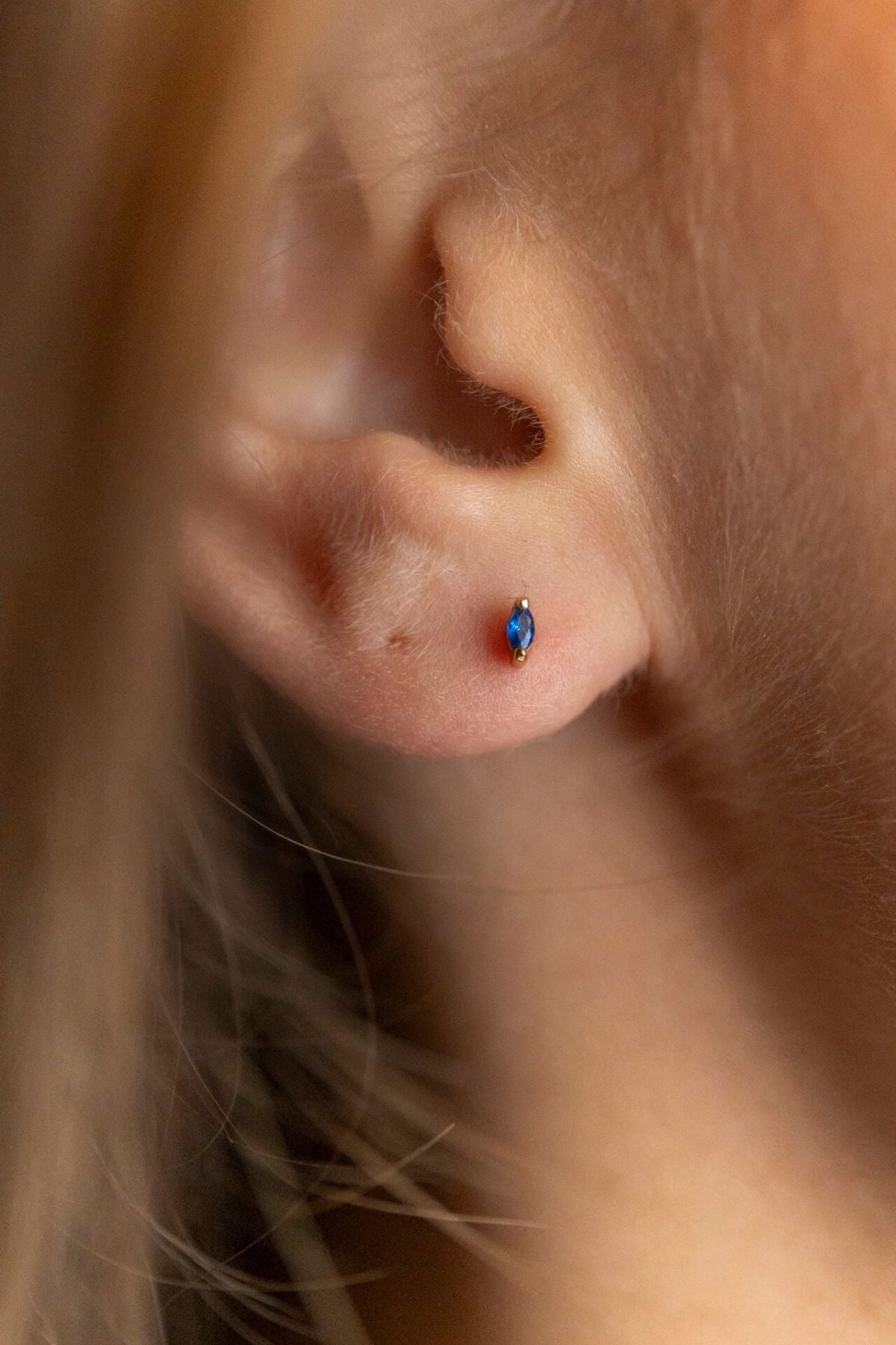 model wears Sapphire Cubic Zirconia Gold Labret Earring