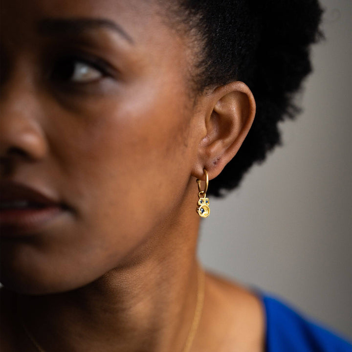 model wears Blue Sapphire and Gold Lichen Birthstone Hoop Earrings