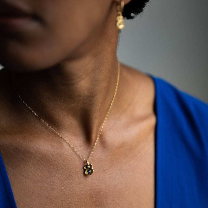 model wears sapphire gemstone and 14k gold vermeil birthstone pendant necklace