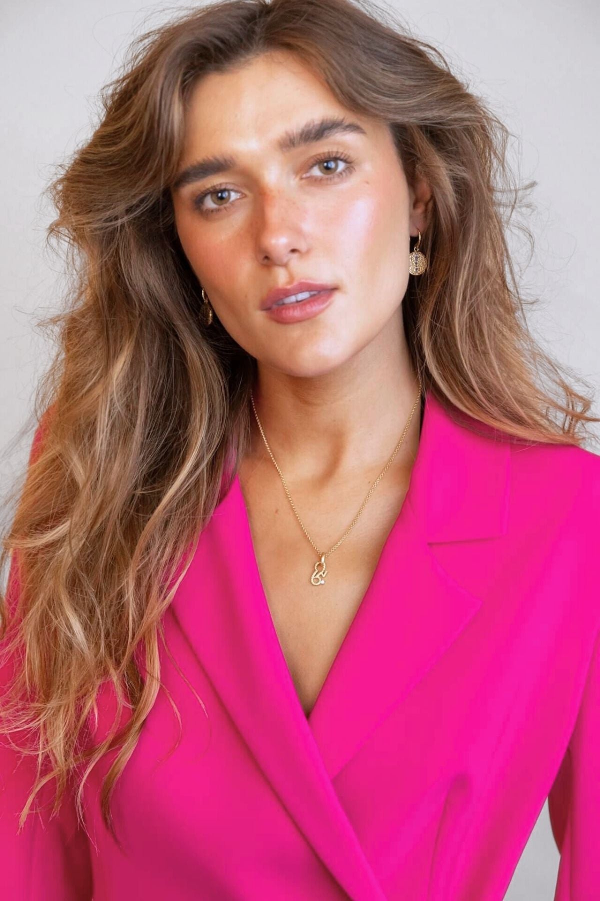 model wears sapphire gold coin drop earrings and brave gold necklace