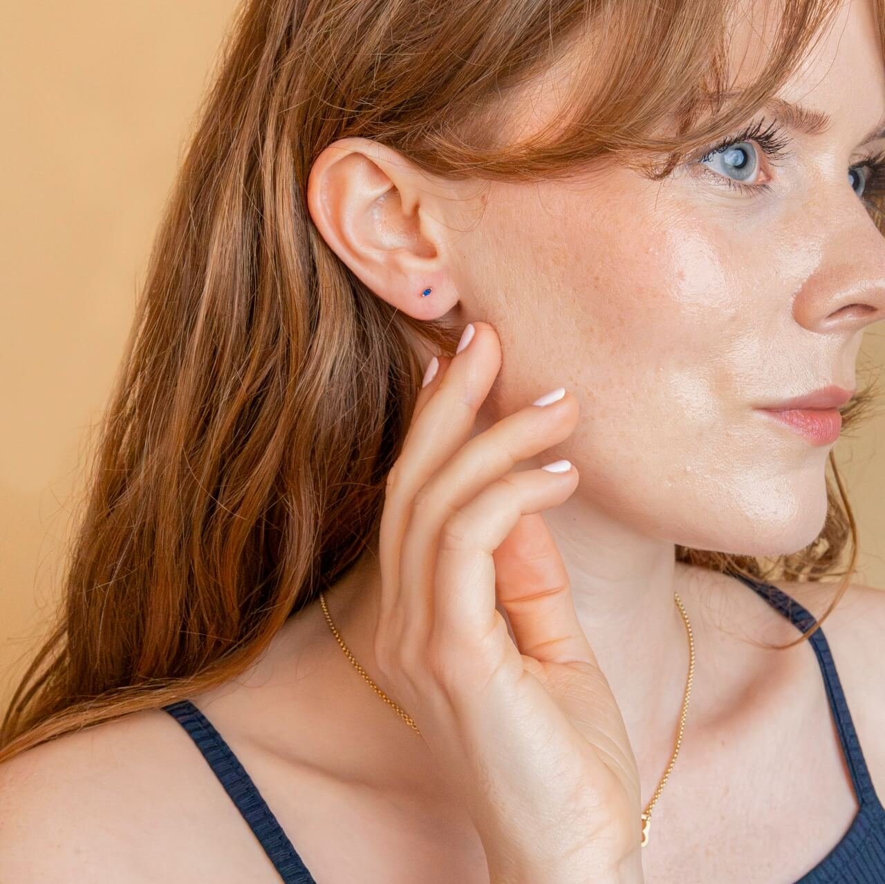 model wears sapphire marquise and 18k gold vermeil labret flat back stud earring