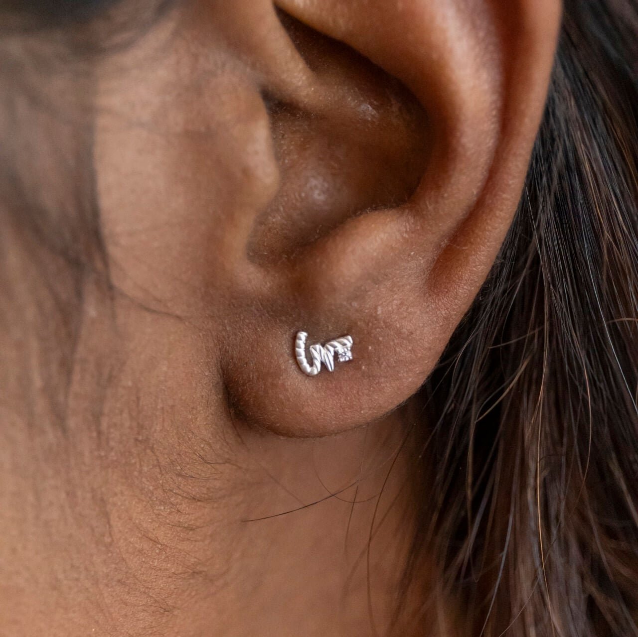 model wears Silver Shorthand Stud Earring meaning Loved - Claire Hill Designs
