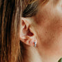 model-wears-silver-and-lapis-lazuli-art-deco-huggie-hoop-earrings-claire-hill-designs