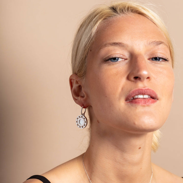 model wears Geometric Mother of Pearl and Silver Statement Hoop Earrings