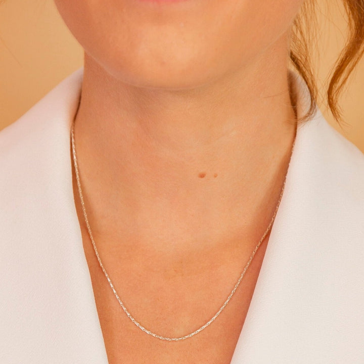 model wears silver barleycorn dainty chain necklace