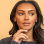 model wears chunky silver huggie hoop earrings