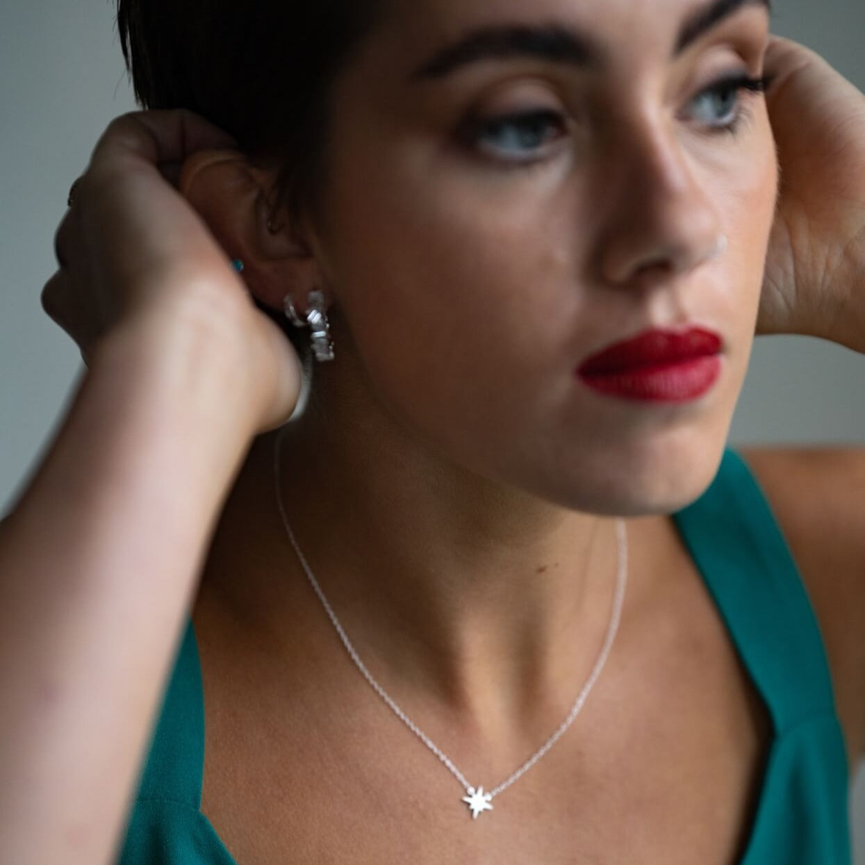 model wears silver brushed north star dainty necklace