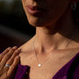 model wears silver brushed north star dainty necklace 