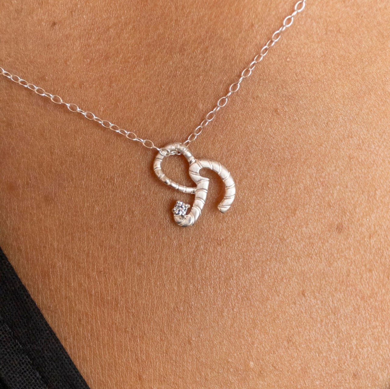 model wears Silver Shorthand Charm Pendant Necklace meaning Courage - Claire Hill Designs 
