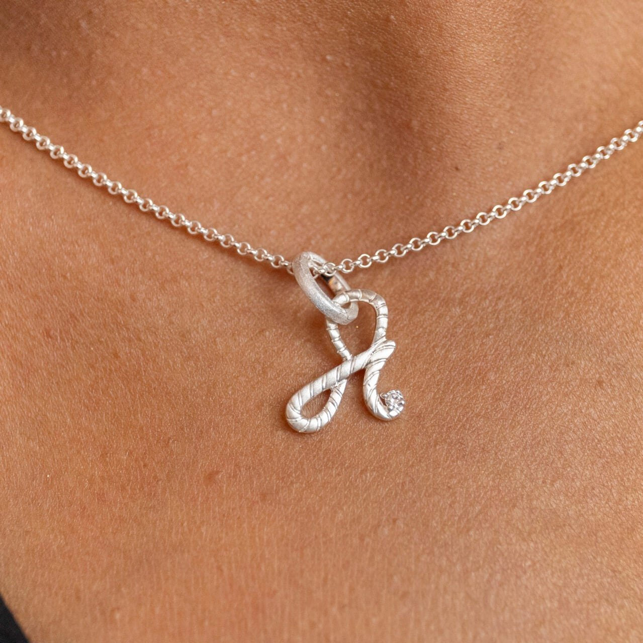 model wears Silver Shorthand Charm Pendant meaning Fearless - Claire Hill Designs