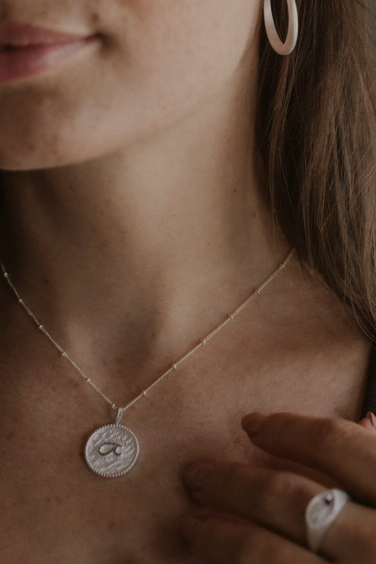 model wears “Fuck” Silver Shorthand Coin Necklace and "Fuck" silver shorthand signet ring