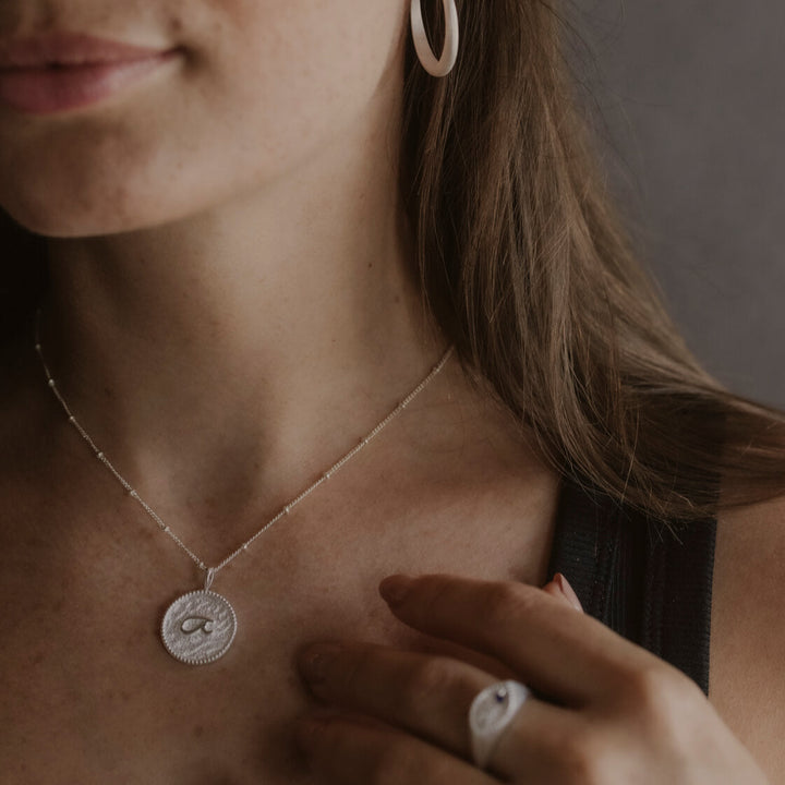 model wears “Fuck” Silver Shorthand Coin Necklace and "Fuck" silver shorthand signet ring