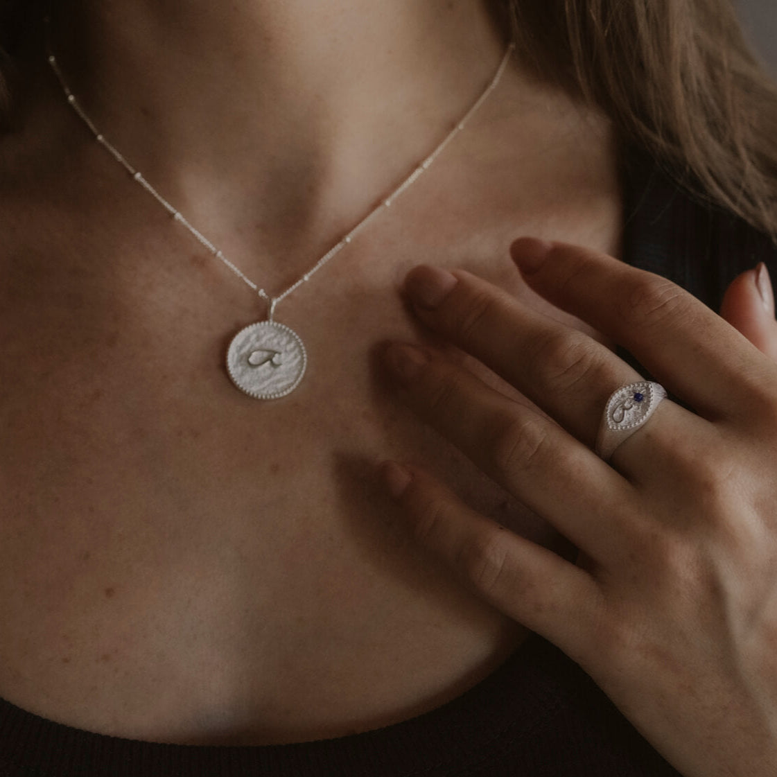 model wears “Fuck” Silver Shorthand Coin Necklace and "Fuck" silver shorthand signet ring
