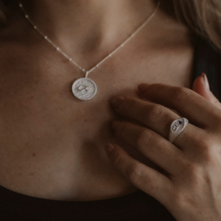 model wears Fuck Silver Shorthand Signet Ring
