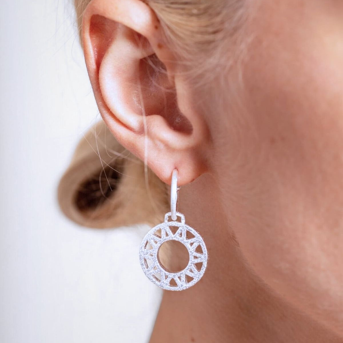 model wears Geometric Statement Silver Hoop Earrings